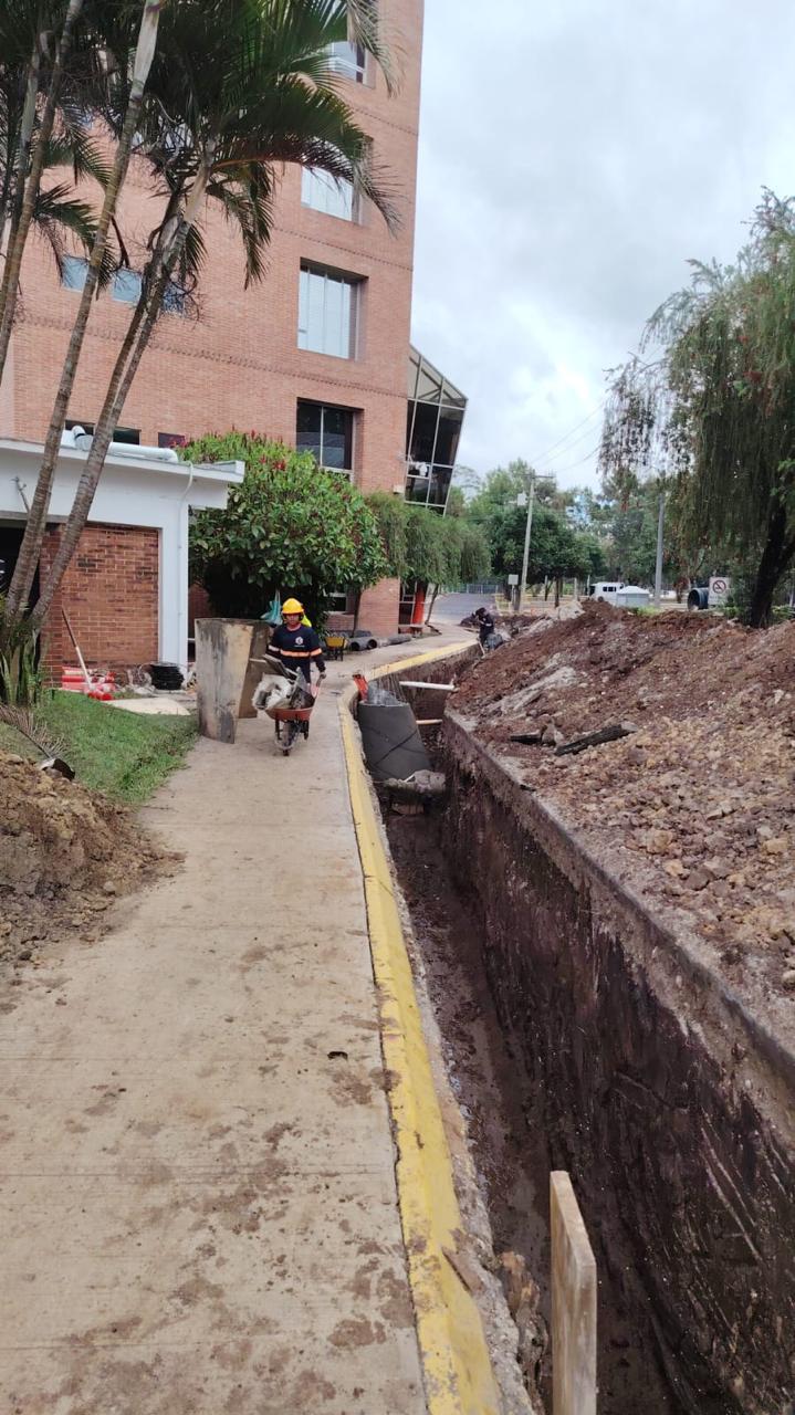 Instalación de tubería en zanja a lo largo de edificio